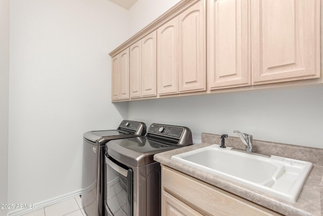 laundry area with tile patterned flooring, a sink, cabinet space, and washer and dryer