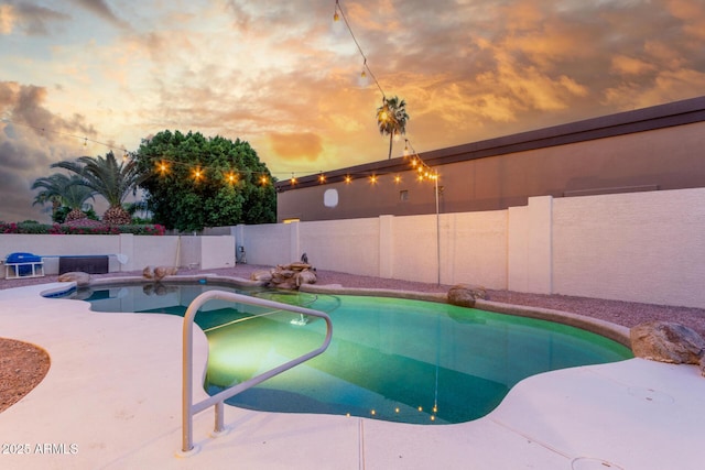 view of swimming pool featuring a fenced backyard, a fenced in pool, and a patio area
