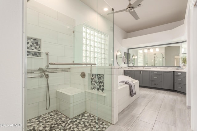 full bath featuring vanity, ceiling fan, visible vents, and a stall shower