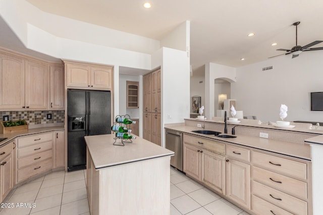 kitchen with light brown cabinets, arched walkways, stainless steel dishwasher, a kitchen island, and black fridge with ice dispenser