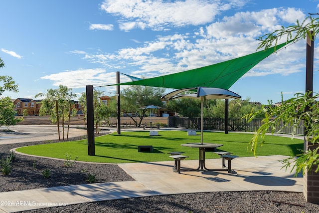 surrounding community featuring fence and a lawn