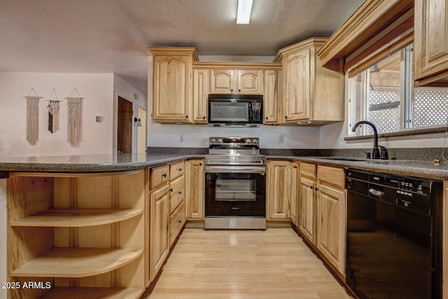 kitchen with open shelves, a sink, light wood-type flooring, black appliances, and dark countertops