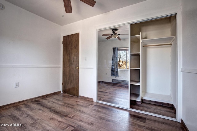 unfurnished bedroom with ceiling fan, a closet, baseboards, and wood finished floors