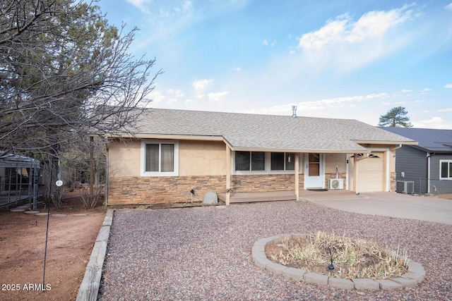 ranch-style house with stone siding, roof with shingles, driveway, and stucco siding