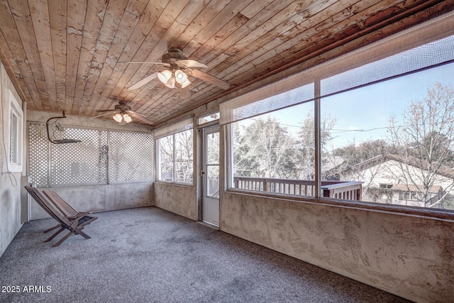 unfurnished sunroom featuring a ceiling fan and wood ceiling