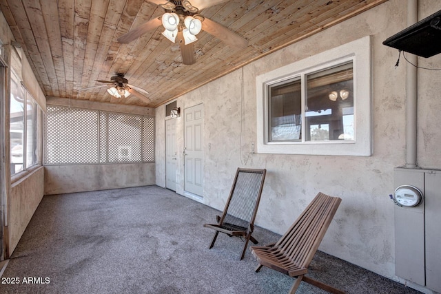 unfurnished sunroom with wood ceiling and ceiling fan