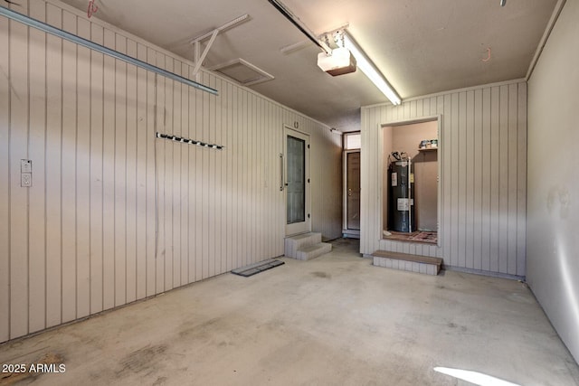 garage featuring a garage door opener and electric water heater