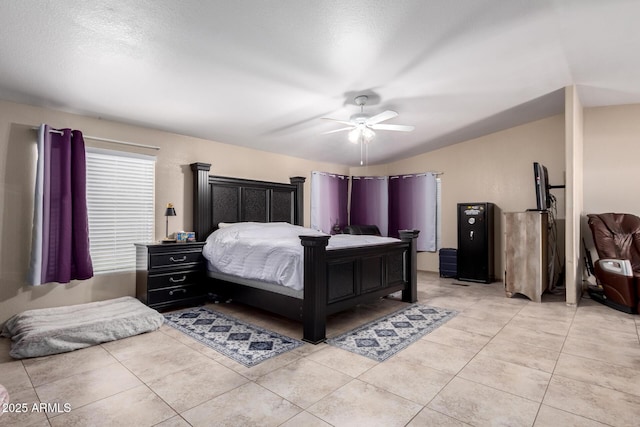 tiled bedroom featuring ceiling fan