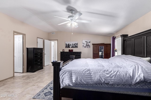 bedroom with vaulted ceiling, light tile patterned floors, and ceiling fan