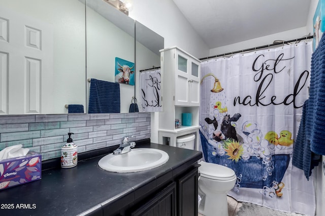 bathroom featuring tasteful backsplash, vanity, a shower with curtain, and toilet