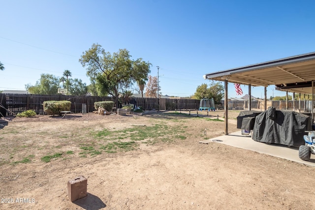 view of yard with a patio area and a trampoline