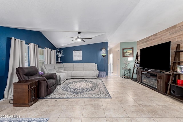 tiled living room featuring ceiling fan and lofted ceiling