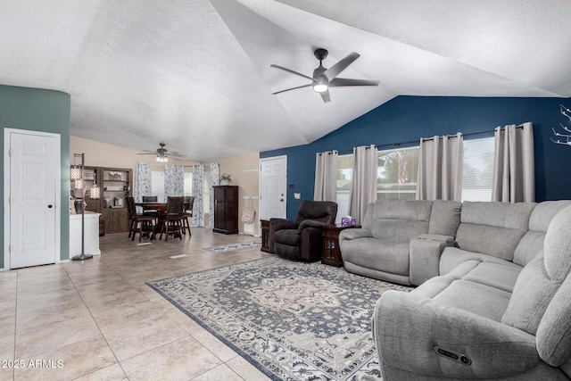 living room featuring a textured ceiling, vaulted ceiling, and ceiling fan