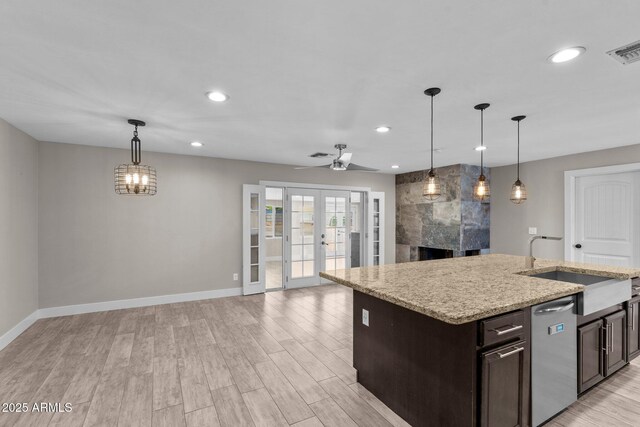 4602 W Monte Cristo Ave, Glendale, AZ 85306 - kitchen featuring dark brown cabinets, open floor plan, baseboards, light wood finished floors, and recessed lighting