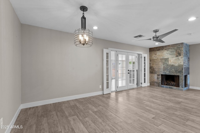 4602 W Monte Cristo Ave, Glendale, AZ 85306 - unfurnished living room featuring recessed lighting, light wood finished floors, baseboards, a ceiling fan, and a large fireplace