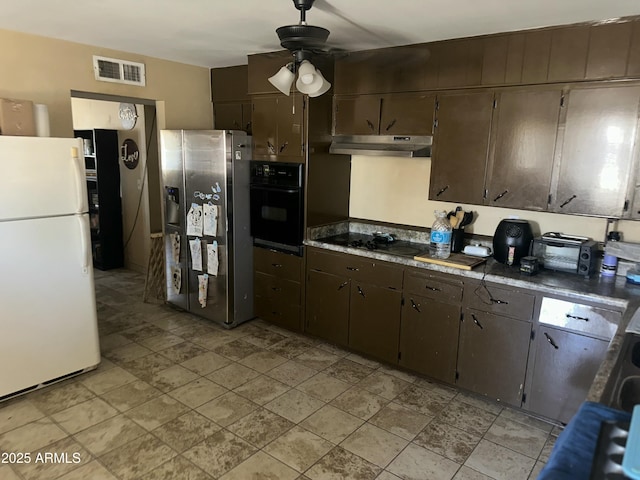 61 W 11th Dr, Mesa, AZ 85210 - kitchen with black appliances, under cabinet range hood, ceiling fan, dark brown cabinets, and light stone finish floors