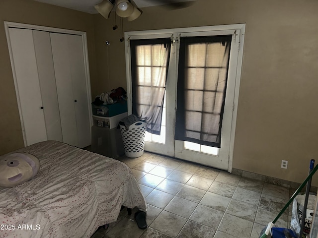 61 W 11th Dr, Mesa, AZ 85210 - tiled bedroom featuring multiple windows, a closet, and baseboards