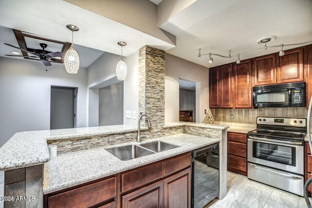 2534 N 52nd St, Phoenix, AZ 85008 - kitchen with backsplash, a sink, light stone countertops, pendant lighting, and black appliances