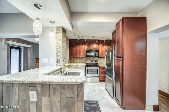 2534 N 52nd St, Phoenix, AZ 85008 - kitchen featuring stainless steel appliances, a sink, light stone countertops, a peninsula, and hanging light fixtures