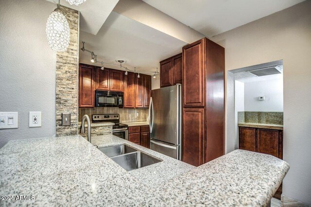 2534 N 52nd St, Phoenix, AZ 85008 - kitchen featuring track lighting, a sink, light stone countertops, decorative backsplash, and appliances with stainless steel finishes