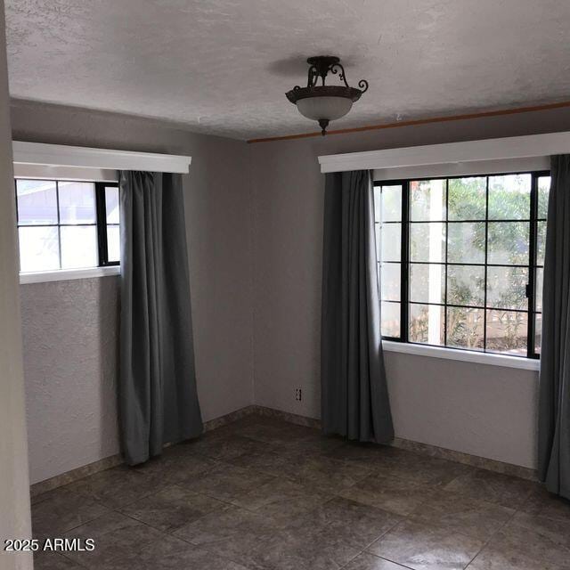 2534 N 52nd St, Phoenix, AZ 85008 - unfurnished room featuring a textured ceiling and baseboards