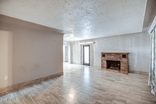 2534 N 52nd St, Phoenix, AZ 85008 - unfurnished living room featuring a textured ceiling and a fireplace