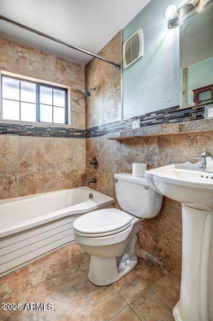 2534 N 52nd St, Phoenix, AZ 85008 - bathroom with toilet, tile patterned flooring, tub / shower combination, and tile walls