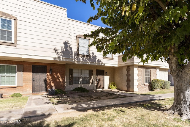 view of front of property featuring brick siding