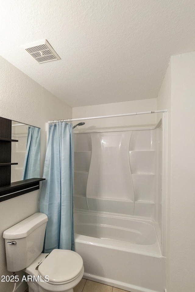 bathroom with tile patterned floors, toilet, shower / tub combo, visible vents, and a textured ceiling
