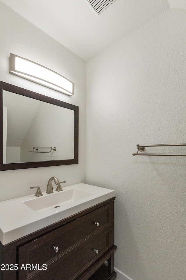 bathroom featuring visible vents and vanity