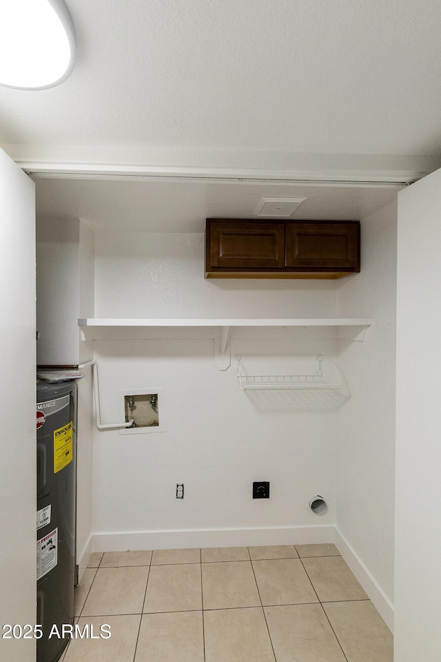 washroom with hookup for an electric dryer, light tile patterned floors, washer hookup, water heater, and baseboards