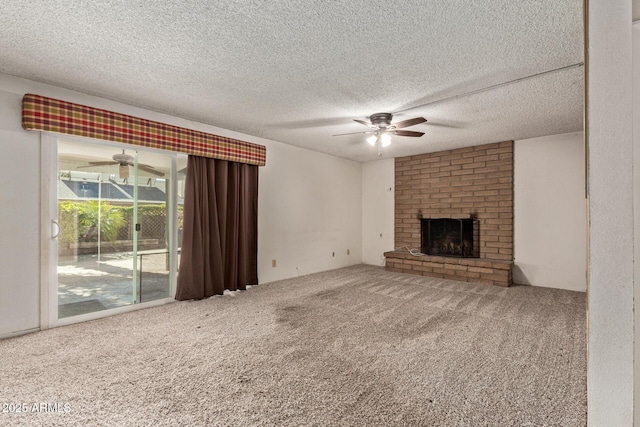 unfurnished living room featuring ceiling fan, carpet, a textured ceiling, and a brick fireplace