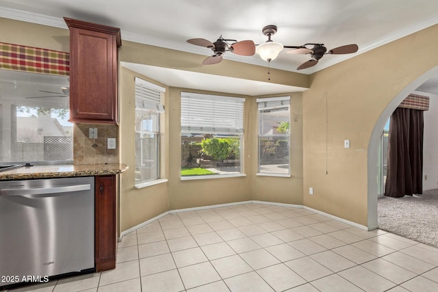 kitchen featuring ornamental molding, light colored carpet, dishwasher, and light stone counters