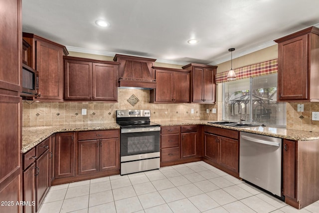 kitchen with appliances with stainless steel finishes, decorative light fixtures, sink, light stone counters, and custom range hood