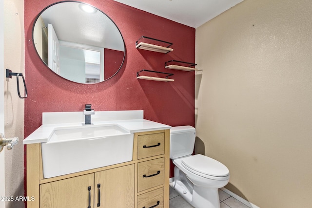 bathroom with vanity, toilet, and tile patterned flooring