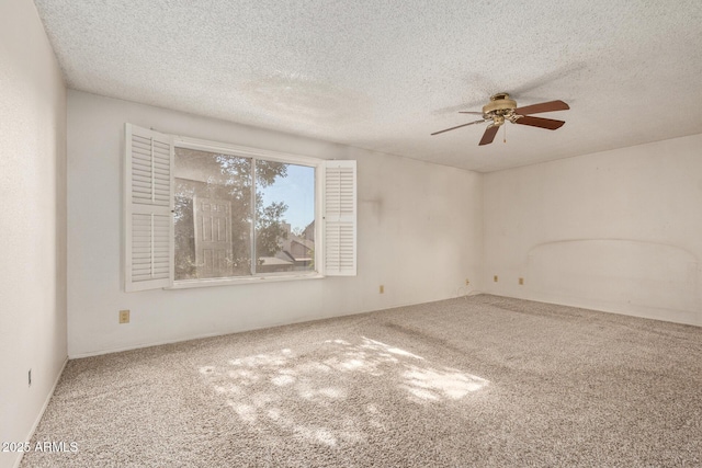 carpeted spare room with a textured ceiling and ceiling fan