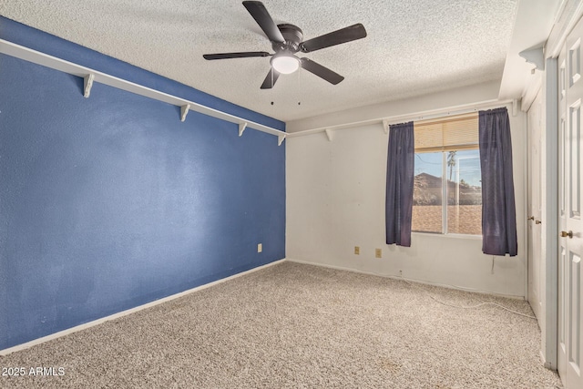 carpeted spare room with ceiling fan and a textured ceiling