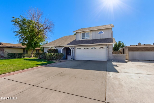 view of front facade with a garage and a front lawn