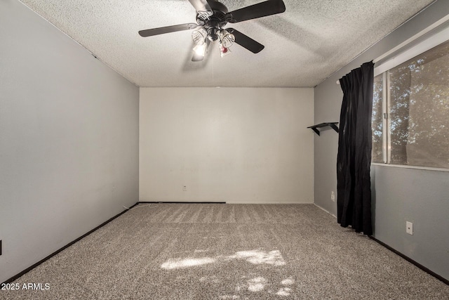 spare room featuring a textured ceiling, ceiling fan, and carpet floors