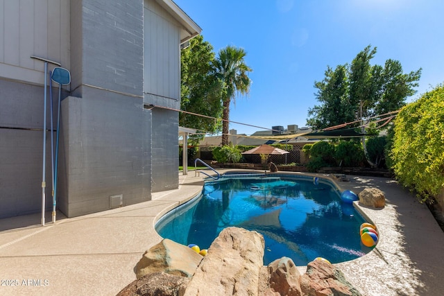 view of swimming pool with a patio area