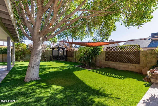 view of yard with central air condition unit and a gazebo