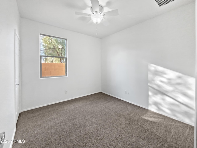 carpeted spare room featuring ceiling fan