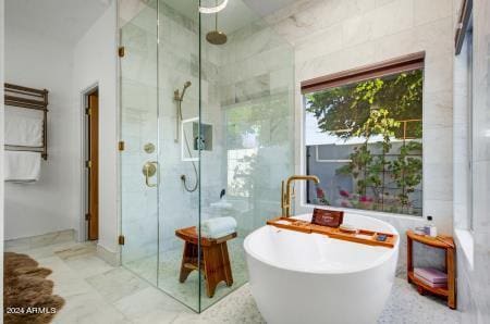 bathroom with separate shower and tub