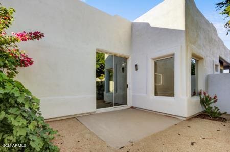 entrance to property with a patio