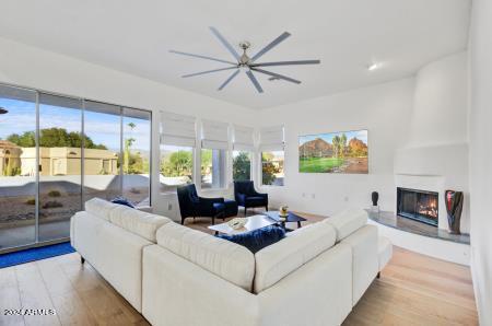 living room featuring light hardwood / wood-style floors and ceiling fan