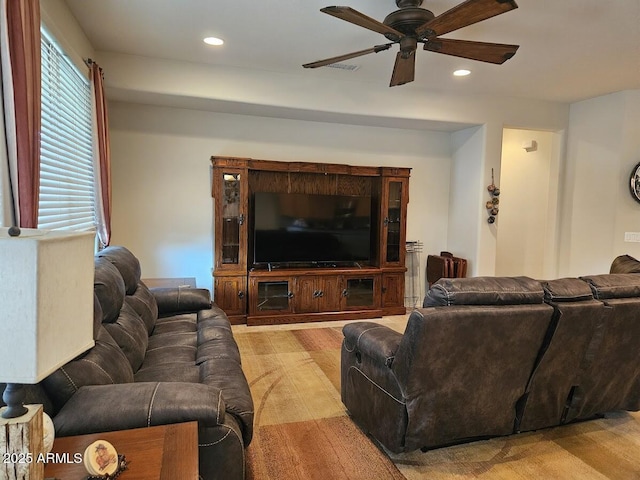 living room with ceiling fan, recessed lighting, light wood-style flooring, and visible vents