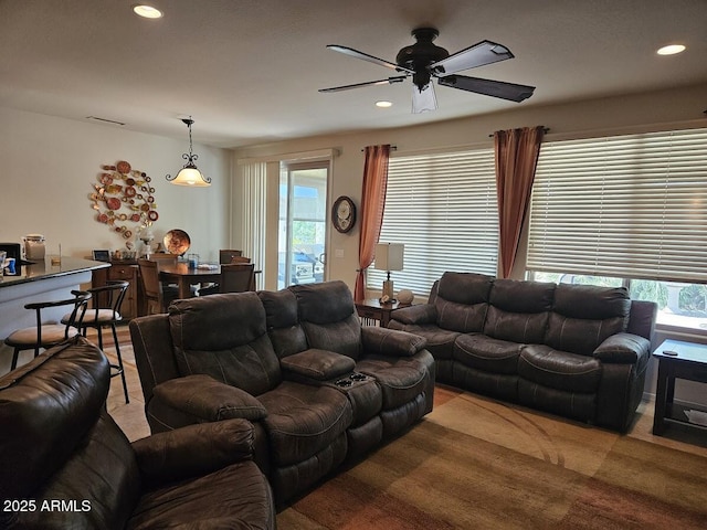 living room featuring ceiling fan, recessed lighting, and visible vents