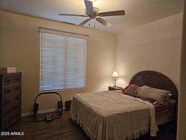 bedroom with ceiling fan, baseboards, visible vents, and wood finished floors