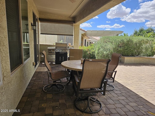 view of patio / terrace with outdoor dining space and a grill