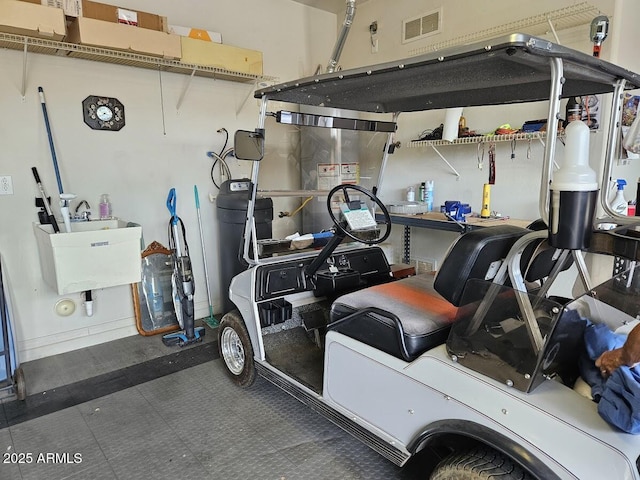 garage featuring visible vents and a sink